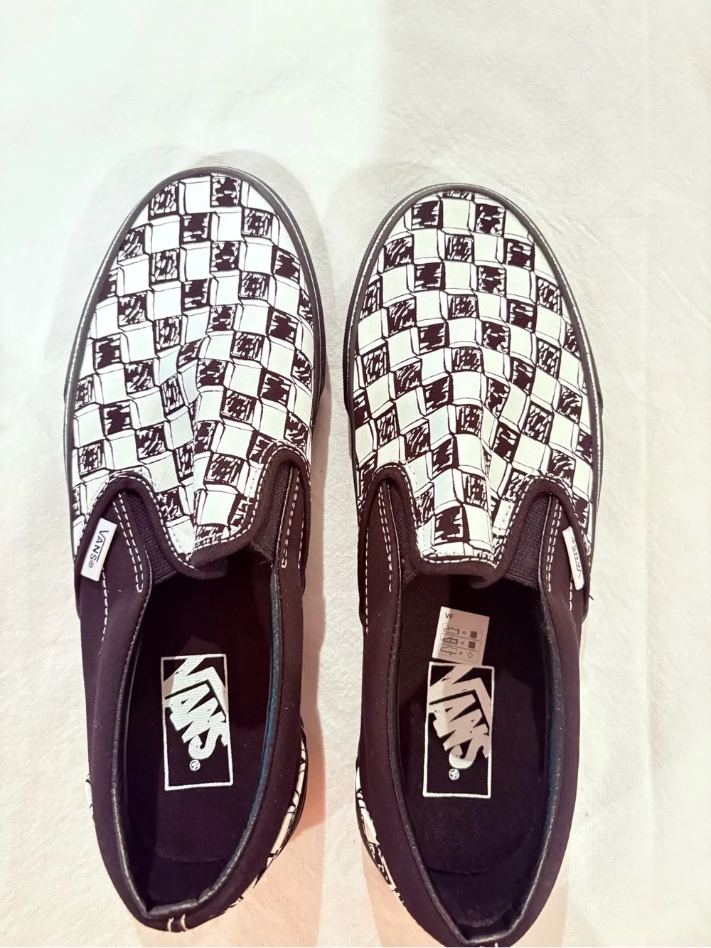 Vans Black and White Checkerboard Slip-On Sneakers